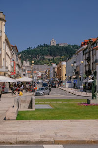 City street by buildings against sky