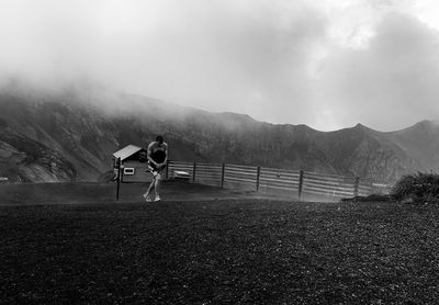 Rear view of person on mountain against sky