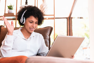 Young woman using laptop at table