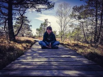 Portrait of man sitting on walkway