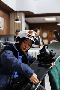 Rear view of man working in factory