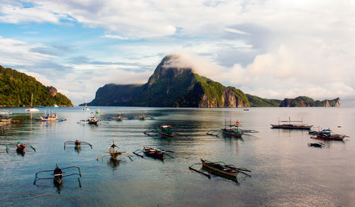 Outrigger canoes moored in lake