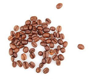 High angle view of coffee beans against white background