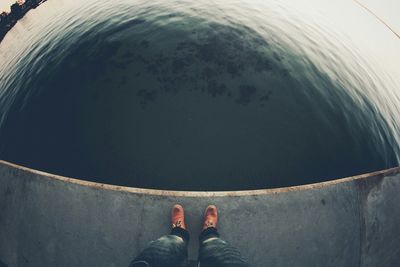 Low section of woman standing in water