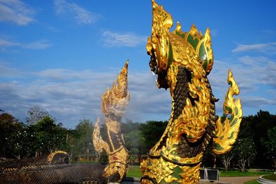 Statue of temple against cloudy sky