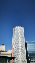 Low angle view of modern building against clear blue sky