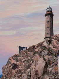 Low angle view of lighthouse against sky during sunset