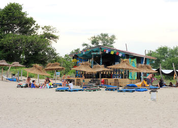 Group of people on beach against sky