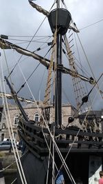 Sailboats moored on sea against sky