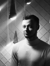 Portrait of young man looking through window