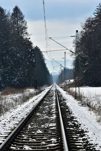 Railroad track against cloudy sky