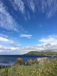 Scenic view of river against blue sky on sunny day