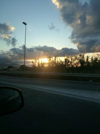 View of street against sky during sunset