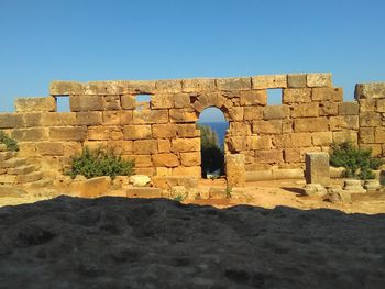 Old ruin building against clear blue sky