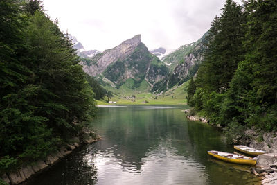 Calm lake with mountains in background