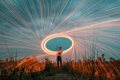 Full length of man standing by light trails