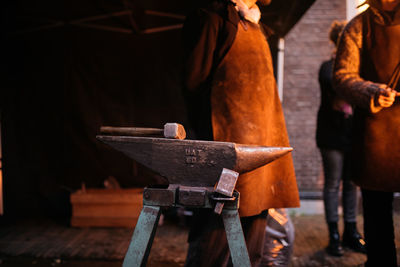 Close-up of man standing on wood