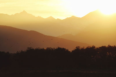 Scenic view of silhouette mountains against sky during sunset