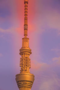 Low angle view of tower against sky during sunset