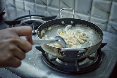 Person preparing food in kitchen at home