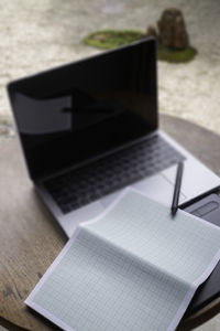 High angle view of laptop and book on table