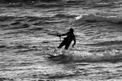 Man kiteboarding in sea