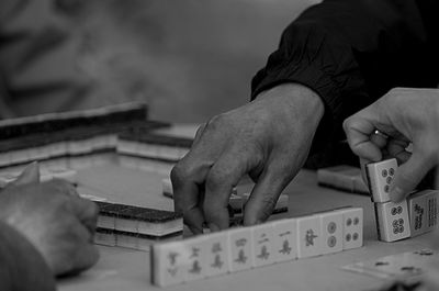 Cropped hands playing with gambling chips on table