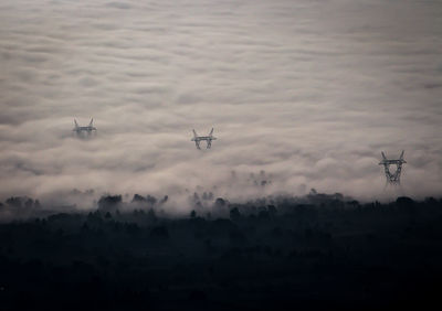 Silhouette of birds flying in sky