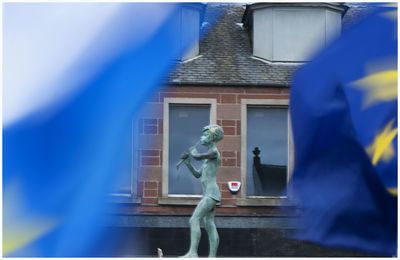 Statue against building
