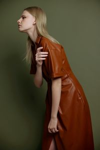 Young woman standing against white background