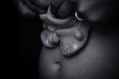 Close-up of hands against black background