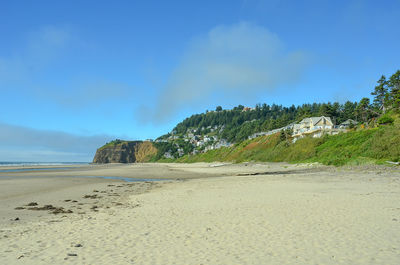 Scenic view of beach against blue sky