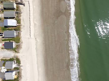 Aerial view of beach and cabins during sunny day