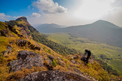 Hiker on mountain against sky