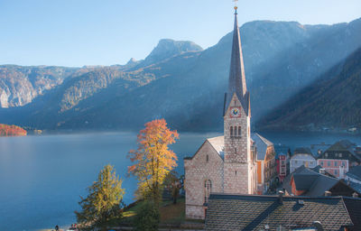 Panoramic view of buildings and mountain against sky