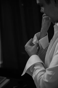 Side view of woman holding hands