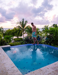 Full length of boy jumping in swimming pool