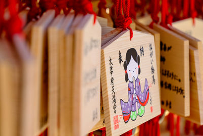 Close-up of wooden prayer planks at a japanese shrine.