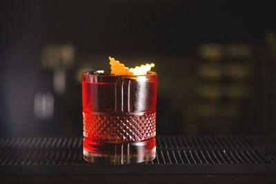 Close-up of red coctail glass on bar table