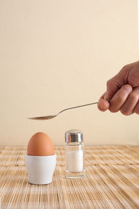 Midsection of person having breakfast on table