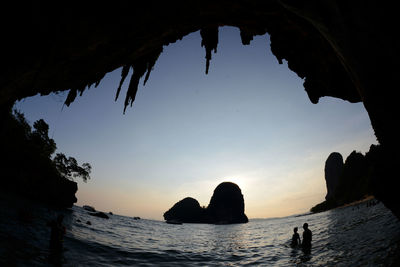 Scenic view of sea against sky seen from cave during sunset