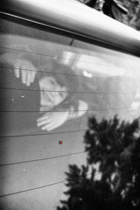 Close-up of man on window