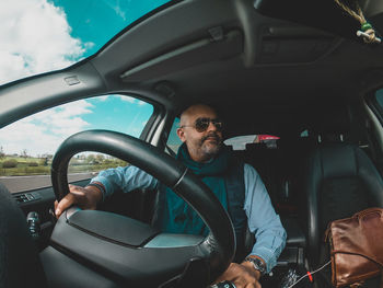 Portrait of man sitting in car