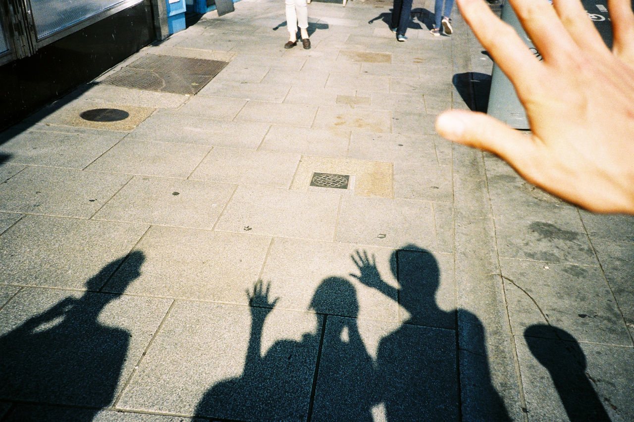 SHADOW OF PEOPLE ON ZEBRA CROSSING