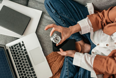 High angle view of people using laptop at home