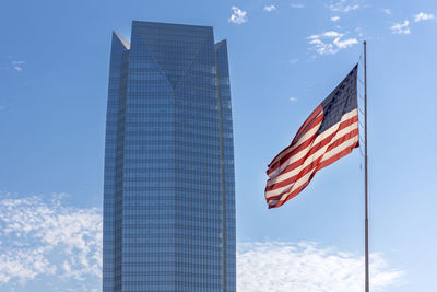 Low angle view of american flag against sky