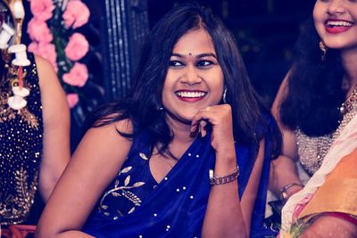 Happy young woman in traditional clothing at night