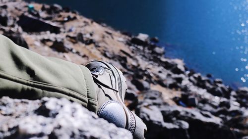 Close-up of shoes on beach