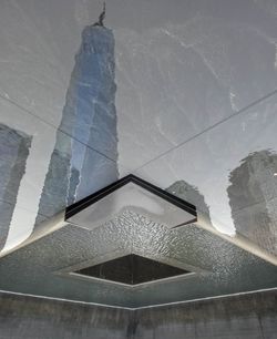 Low angle view of glass building during winter