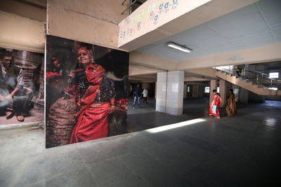 People walking in corridor of building